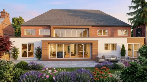 A wide, architectural rendering of the rear facade of a large house featuring a modern double-storey extension. The ground floor blends white rendering and light wood cladding, with large glass bi-fold doors opening onto a stone patio with outdoor seating and a fire pit. The upper storey features red brickwork with large windows, all under a vast hipped roof. The foreground is filled with a lush garden full of purple, pink, and orange flowers under a soft twilight sky.